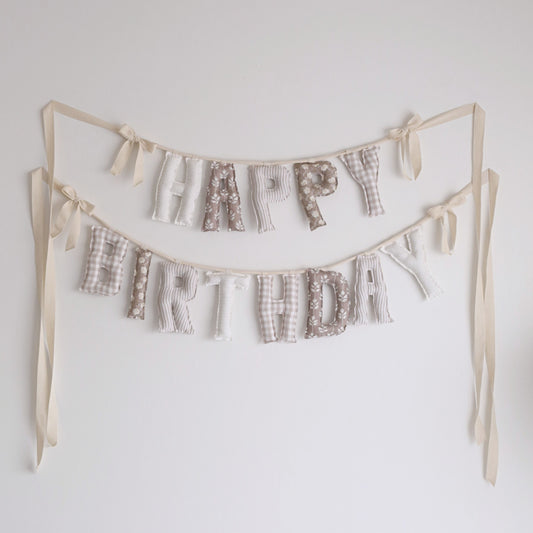 Antique Birch handmade ‘Happy Birthday’ garland by Social Heirloom – warm neutral tones in cream, taupe, and soft brown with floral and gingham prints, tied with natural twill bows for timeless, heirloom celebrations