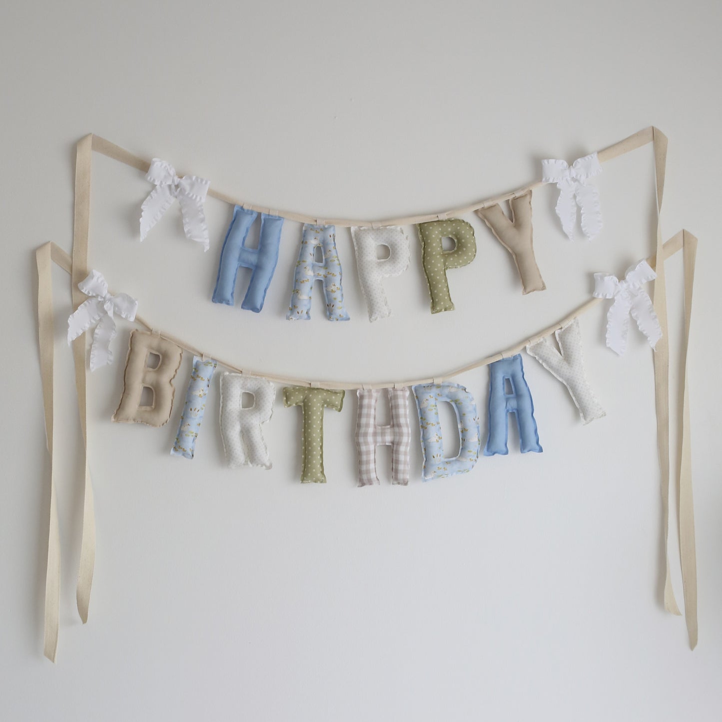 Lucky Duck handmade ‘Happy Birthday’ garland by Social Heirloom – soft blues, greens, and creams with gingham and duck-printed fabrics, finished with white ruffle bows, perfect for boys’ birthdays or a ‘One Lucky Duck’ theme