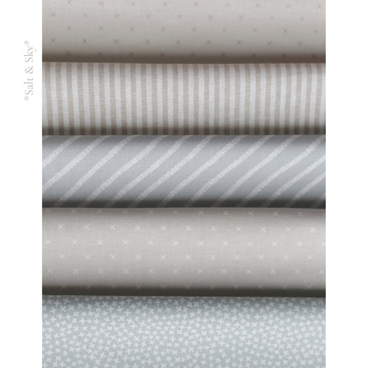Salt and Sky fabric palette by Social Heirloom – soft blues, cool greys, and warm taupe stripes and prints used in handmade birthday and name garlands for nurseries, gifts, and first birthdays