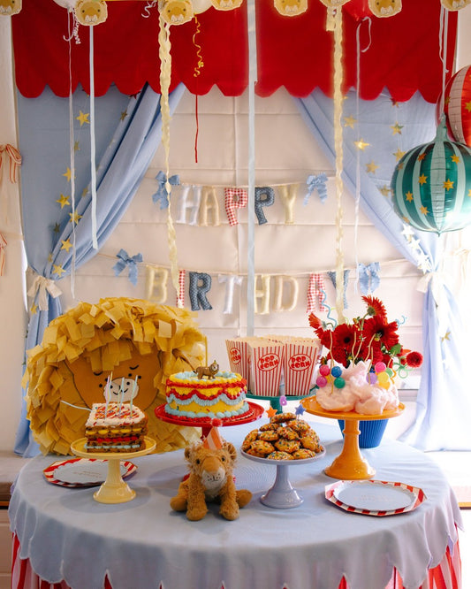 Lion party cake table under the Willow Creek Fair garland