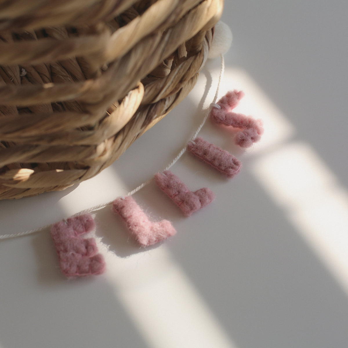 Close up of ELLIS little felt garland showing the hand stitched felt letters