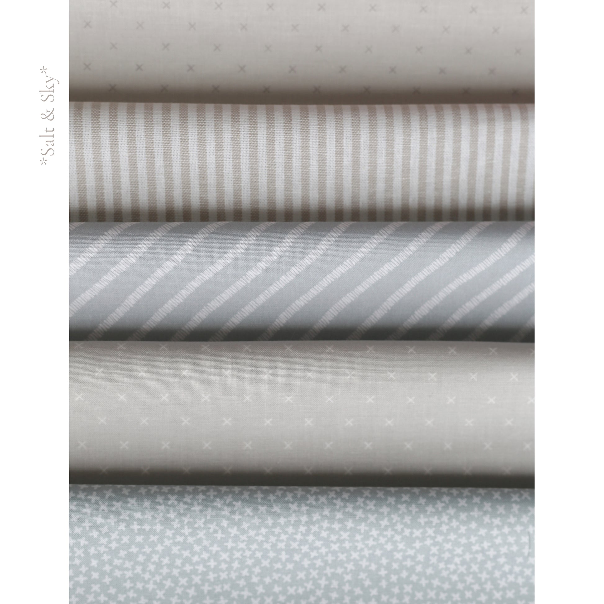 Salt and Sky fabric palette by Social Heirloom – soft blues, cool greys, and warm taupe stripes and prints used in handmade birthday and name garlands for nurseries, gifts, and first birthdays