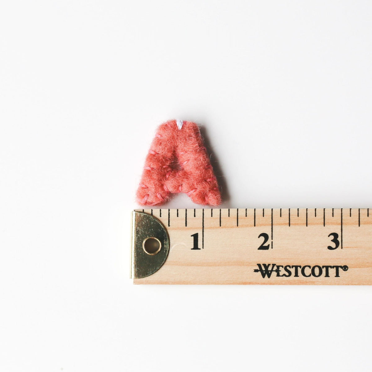 Little felt letter A next to a ruler, letters are about 1.2 inches tall