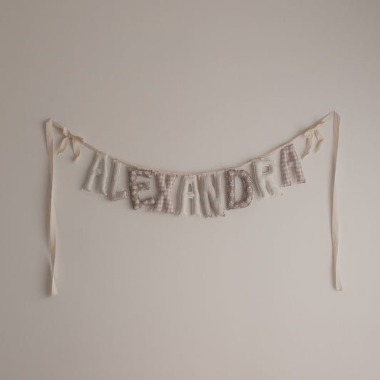 Textual decoration spelling 'ALEXANDRA' on a plain wall.