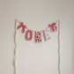 Berry Sweet personalized name garland spelling ONE, handmade fabric letters in strawberry prints, berry pinks and sweet pink polka dots by Social Heirloom