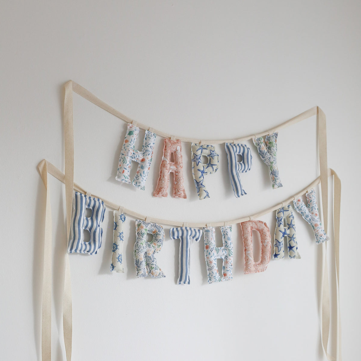 Custom mix Happy Birthday garland in mixed blue stripes, florals and blush fabrics, handmade by Social Heirloom