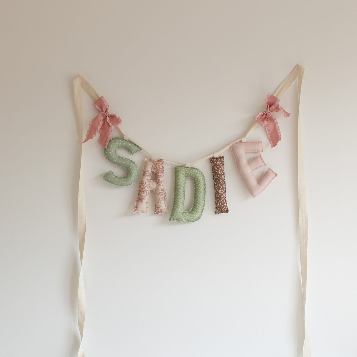 Custom Mix name garland spelling SADIE in sage and blush prints with pink bows