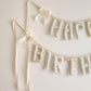 Close up of the Honey & Bloom Happy Birthday garland, soft filled fabric letters in pale vintage florals of blush, cream and buttery yellow