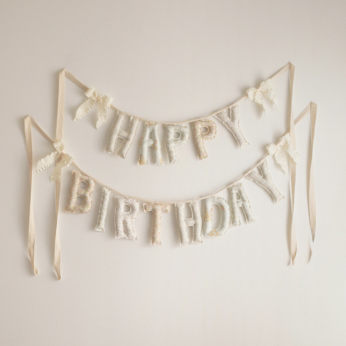 Honey & Bloom Happy Birthday garland by Social Heirloom, handmade fabric letters in pale vintage florals of blush, cream and buttery yellow