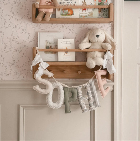 Blush & Olive name garland by Social Heirloom — styled photo of a handmade, personalized fabric name banner; a keepsake nursery and celebration decor piece, made to order.