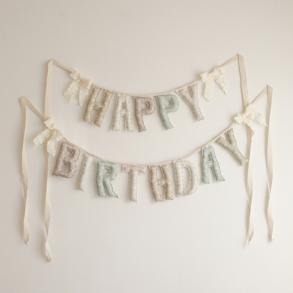 Sunday Cottage Happy Birthday garland by Social Heirloom, handmade fabric letters in tiny florals across taupe, cream, dusty rose, sage and blush